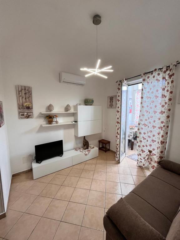a living room with a couch and a tv at House del Corso Calatafimi in Palermo