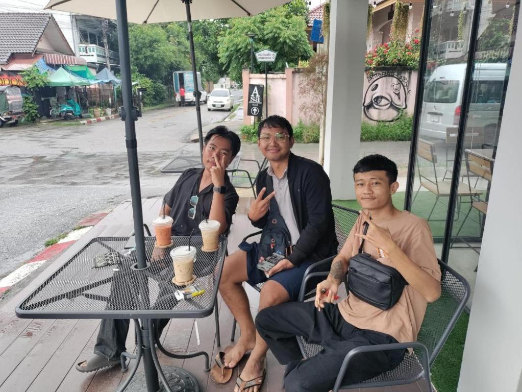 a group of three people sitting at a table at Lazy Gibbon 2 Chiang Mai - Haiya in Chiang Mai