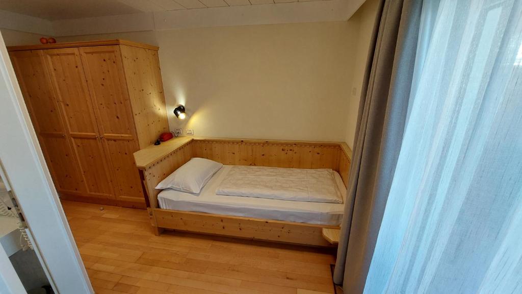 Postel nebo postele na pokoji v ubytování Hotel Cristallo