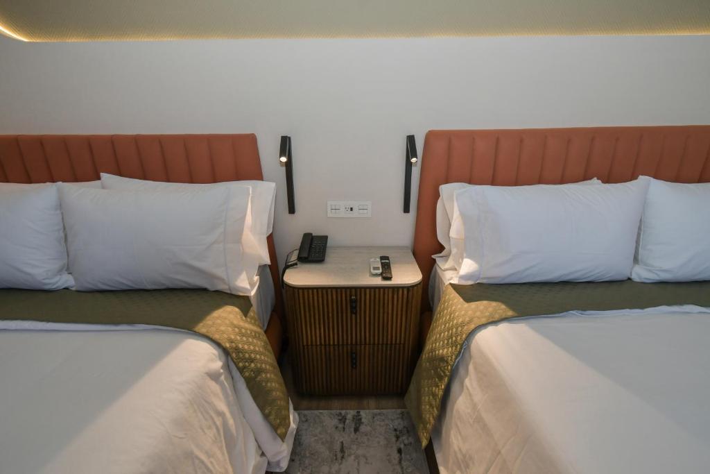 Postel nebo postele na pokoji v ubytování Expo Satelite 2750 Hotel & Suites