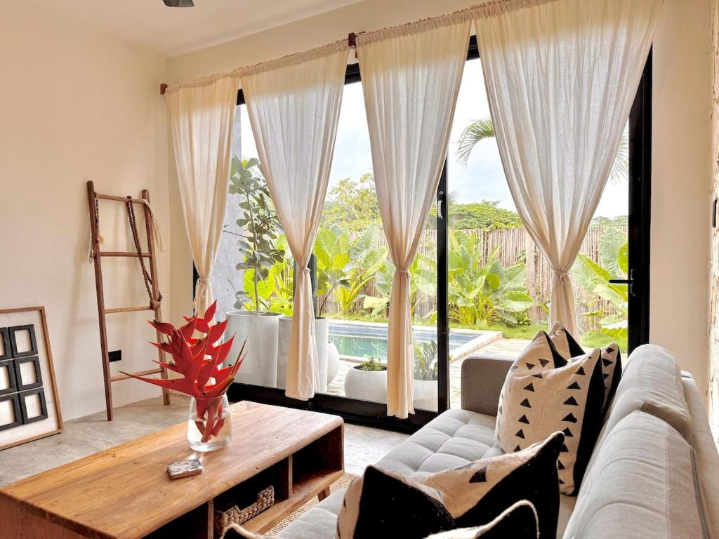 a living room with a couch and a table at Casa Ola, luxurious jungle house in El Valle