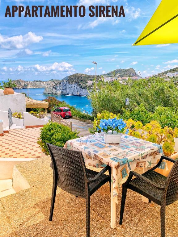 a table and chairs with a view of the ocean at Ponzamania IL Pescatore in Ponza
