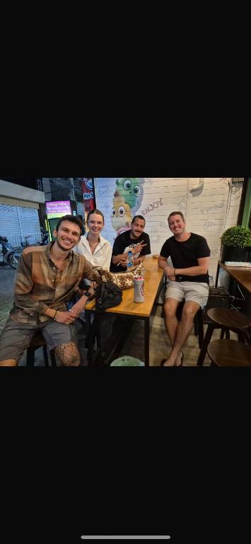 a group of men sitting around a table at Lazy Gibbon 2 Chiang Mai - Haiya in Chiang Mai