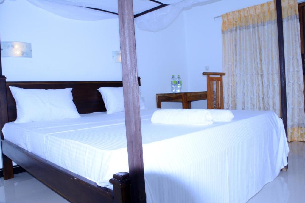 Postel nebo postele na pokoji v ubytování Relax Beach Arugambay