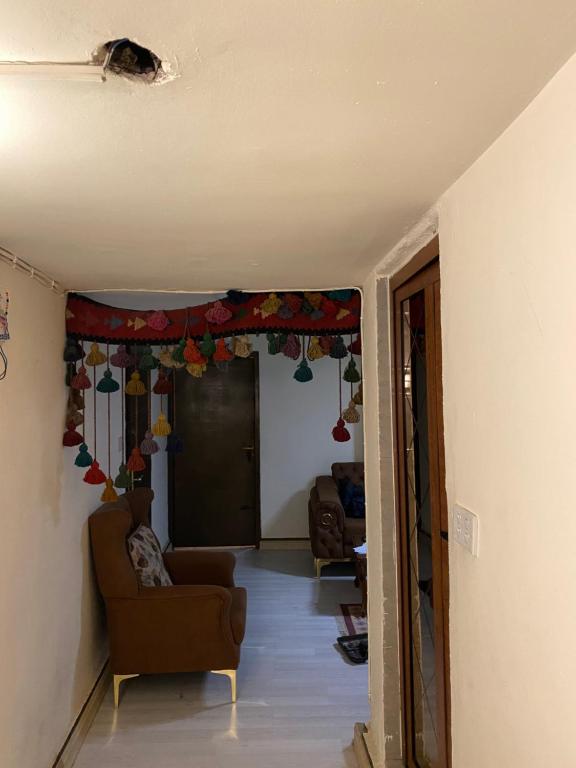 a living room with a couch and a chair in a room at Karada Abu Nawas private room in Baghdad