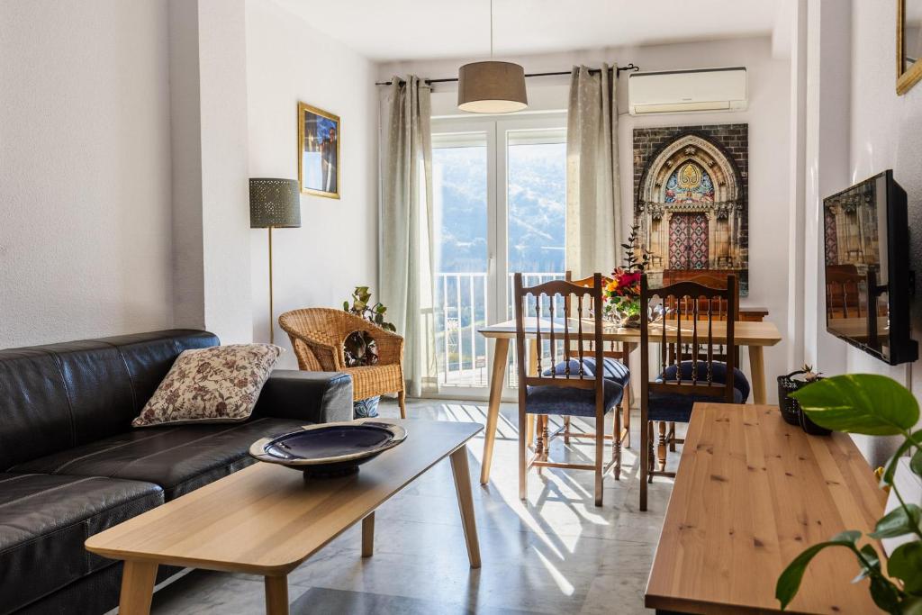 a living room with a couch and a table at Apartamentos Sendero del Veleta in Cenes de la Vega