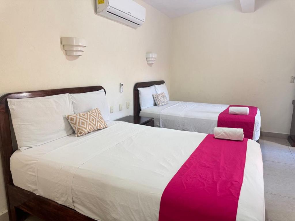 Postel nebo postele na pokoji v ubytování Hotel Caribe