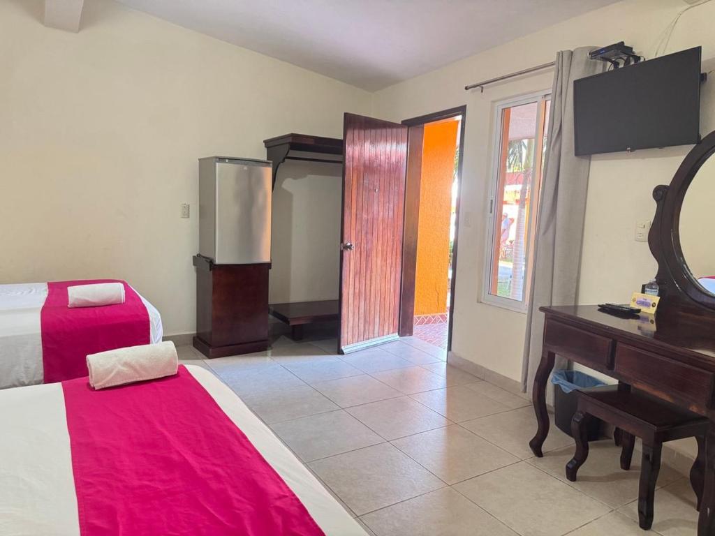 Postel nebo postele na pokoji v ubytování Hotel Caribe