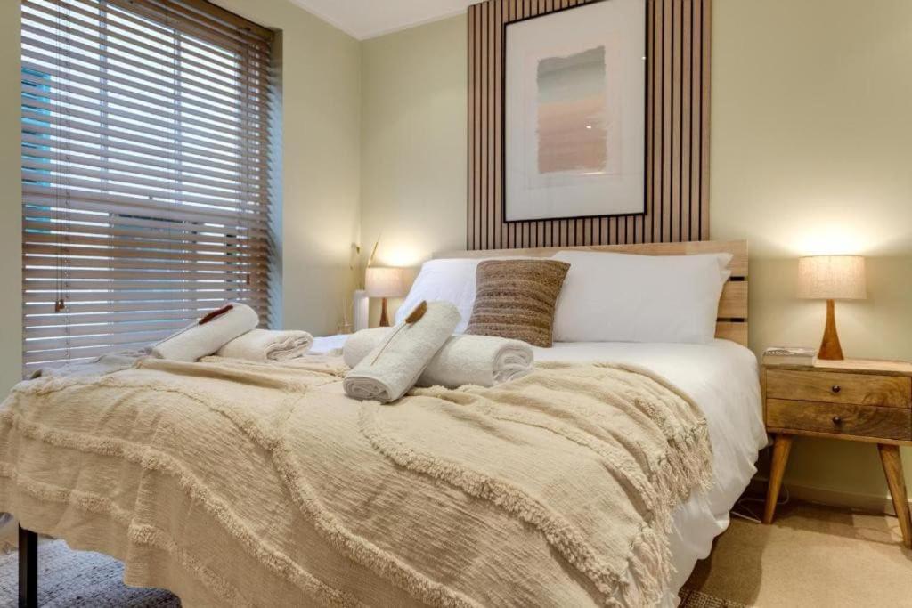 a bedroom with a large bed with a large window at Tower Hideaway Flat in city centre area of Canterbury in Canterbury