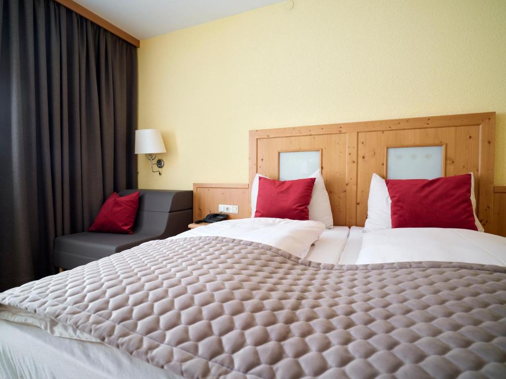 Postel nebo postele na pokoji v ubytování Hotel Hierzegger