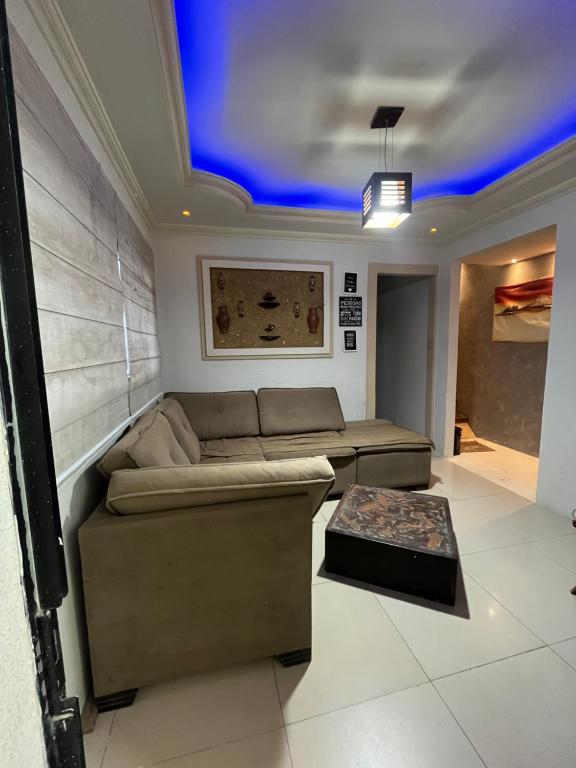 a living room with a couch and a table at Casa Central in Porto Seguro