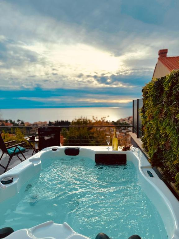 a hot tub on a balcony with a view at Deluxe Apartman Dubrovnik in Dubrovnik