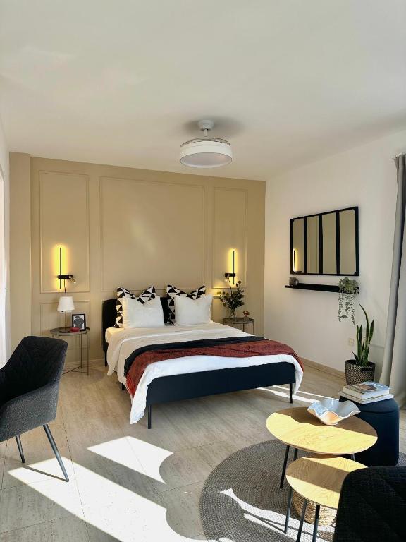 a bedroom with a large bed and two tables at Capital in Arrecife