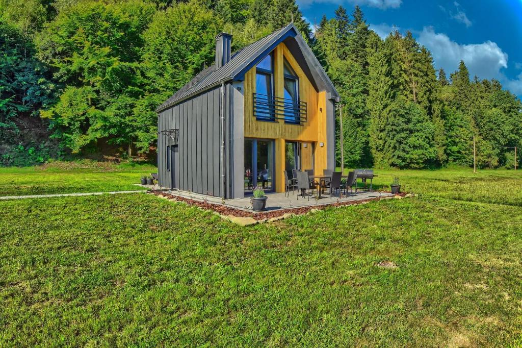 a small house in the middle of a field at Osada Pod Maliną in Brenna