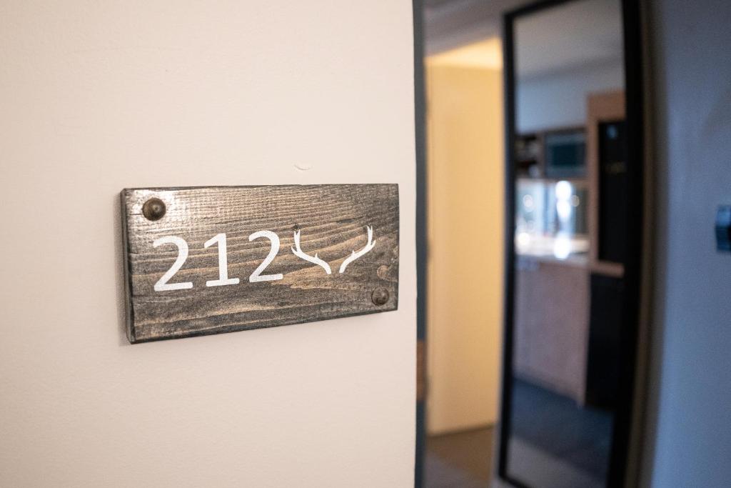 a sign on a door with the on it at Adara Hotel in Whistler