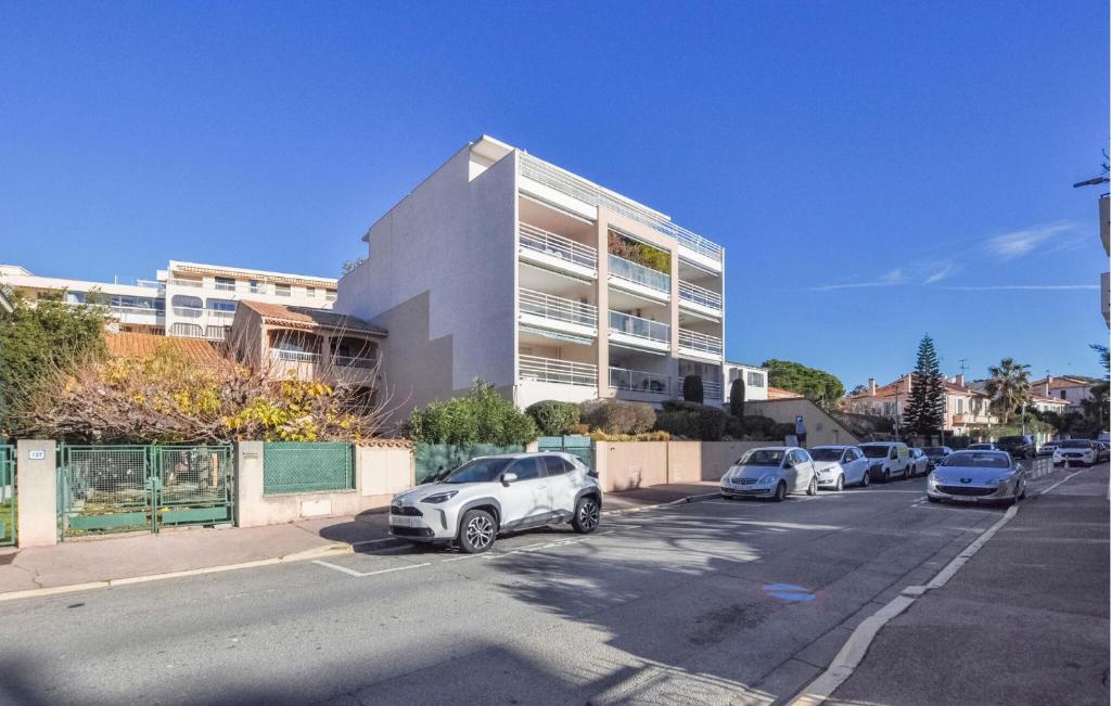 a parking lot with cars parked in front of a building at Nice Apartment In Fréjus With Wifi in Fréjus