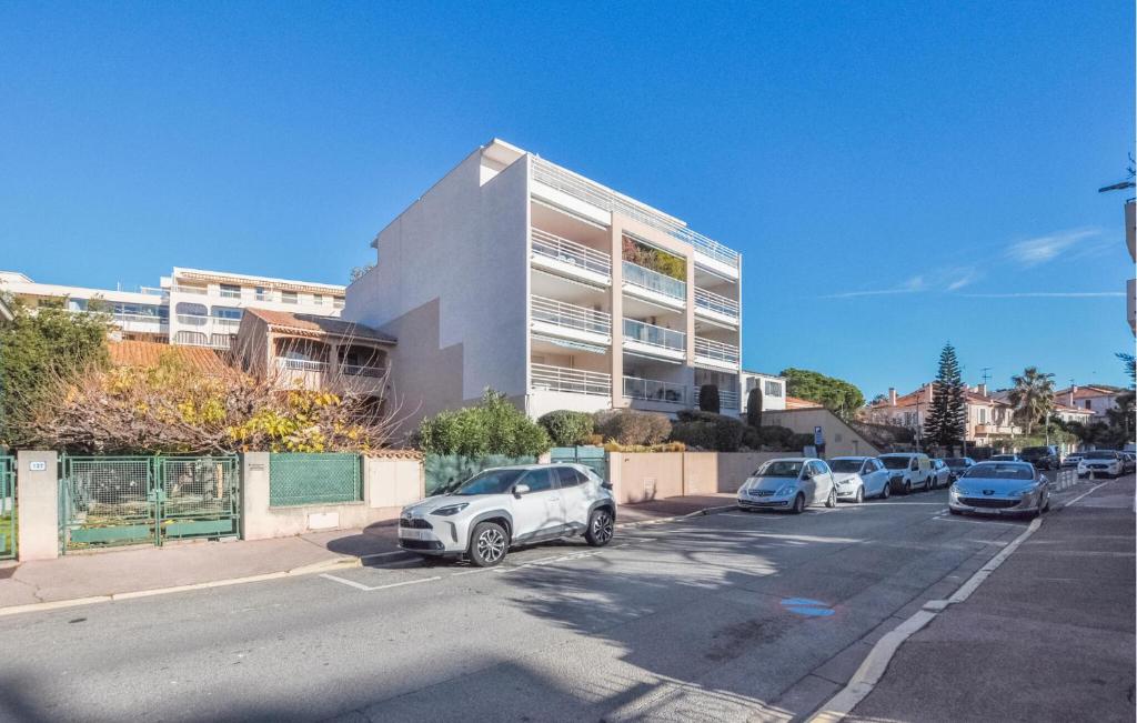 a parking lot with cars parked in front of a building at Lovely Apartment In Fréjus With Wifi in Fréjus