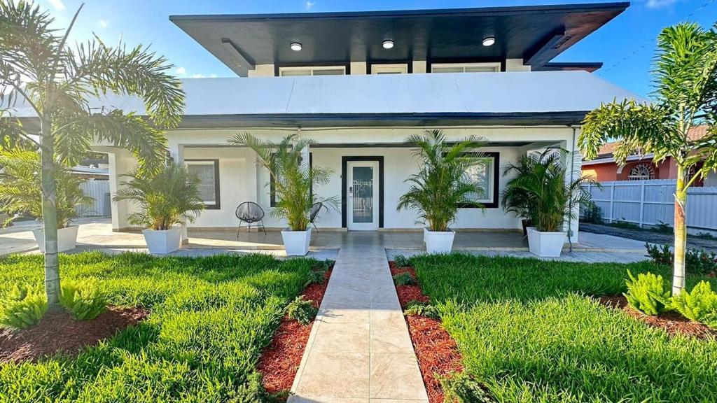 a house with palm trees in the front yard at Luxury Home by Miami Int Airport in Miami