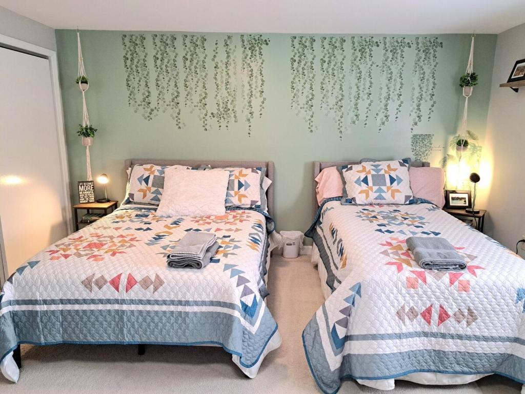 two beds sitting next to each other in a bedroom at Quiet Retreat for Business or Family Trip in Charlotte