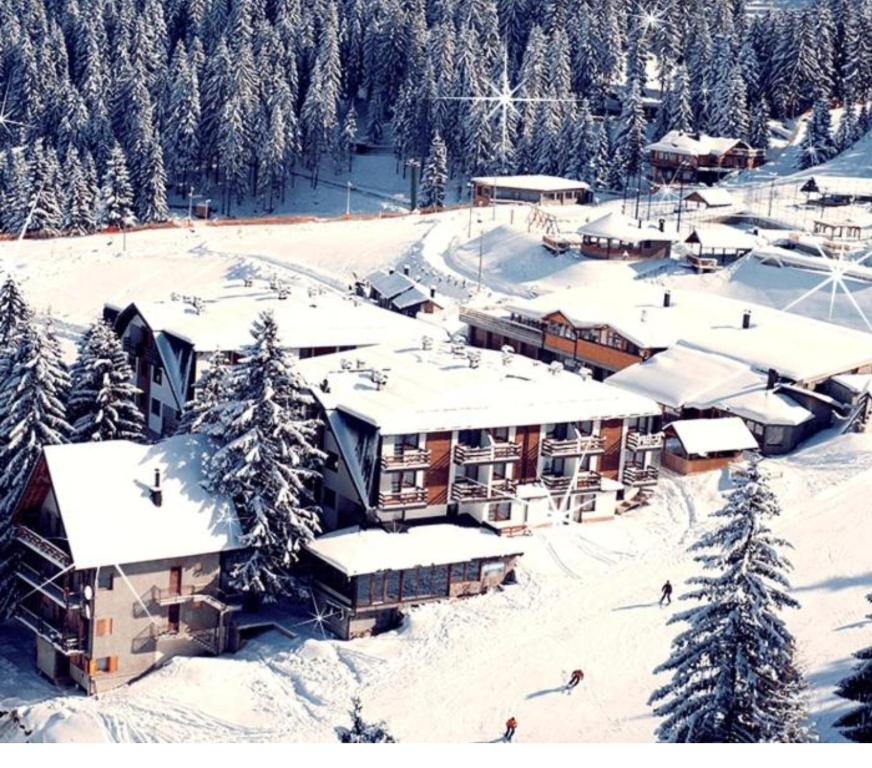 a resort in the snow with snow covered buildings at Vlašićka priča Eko Fis in Vlasic