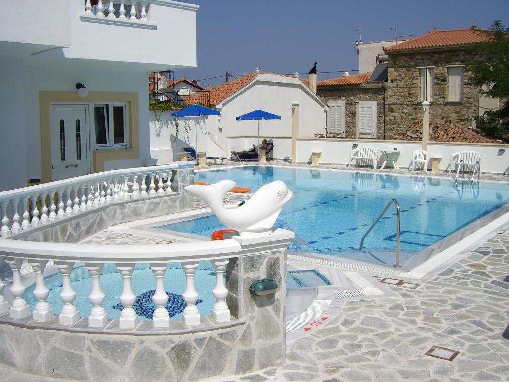a swimming pool with a white chair on a balcony at Apartments Zafiria in Ágios Konstantínos