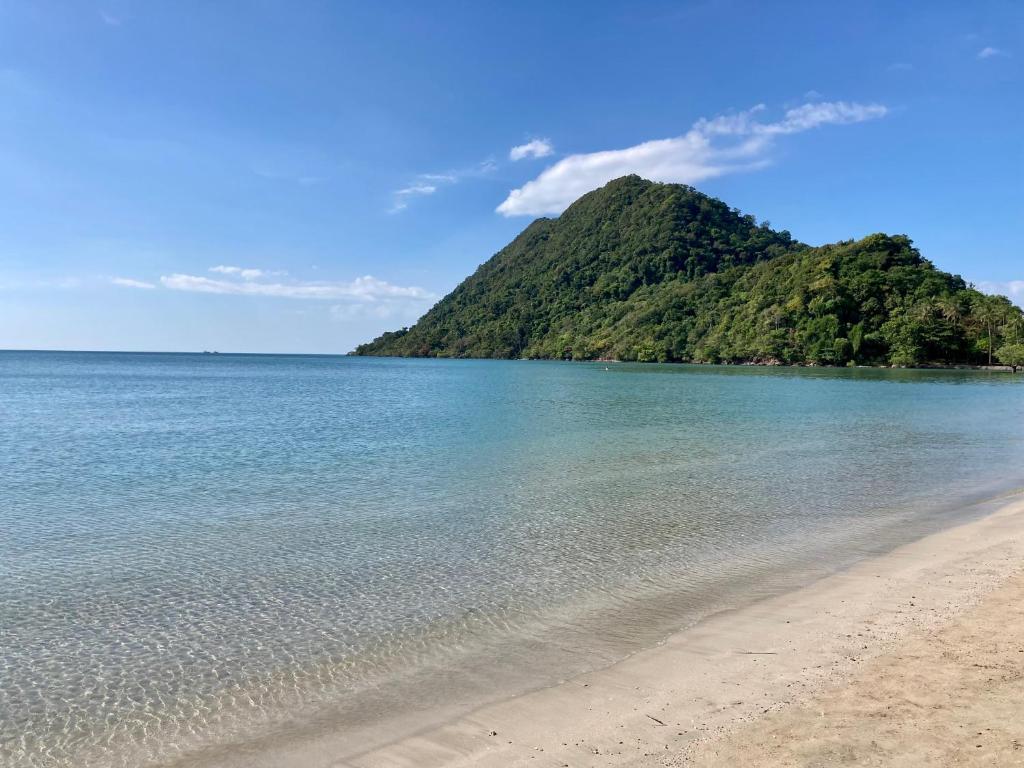 a view of a beach with a mountain in the background at Siam Royal View Pool Villa in Ko Chang
