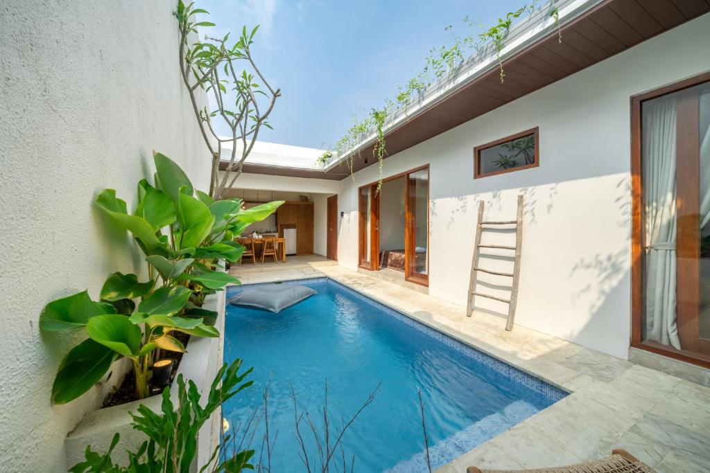 a swimming pool in the backyard of a house at Villa Five Smile Ungasan in Badung