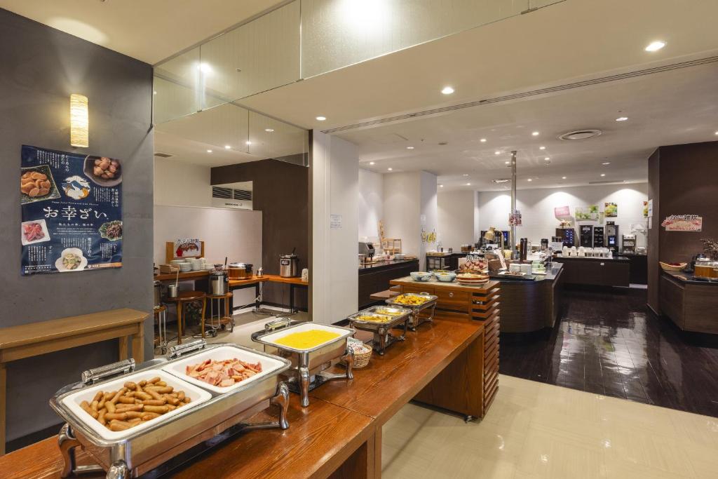 a restaurant with a counter with different types of food at Hotel Fujita Fukui in Fukui