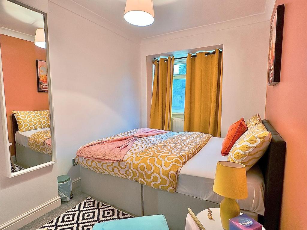 a small bedroom with a bed and a mirror at Your next room in Portsmouth in Portsmouth