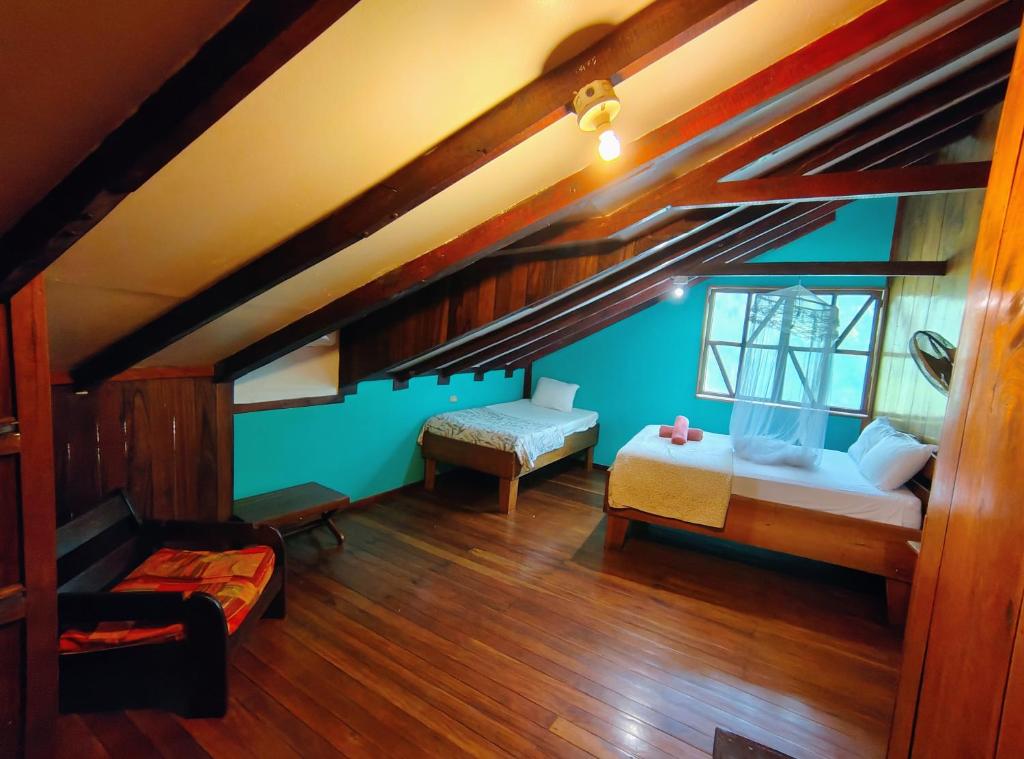 a attic room with a bed and a couch at Vista Drake Lodge in Drake Bay Airport
