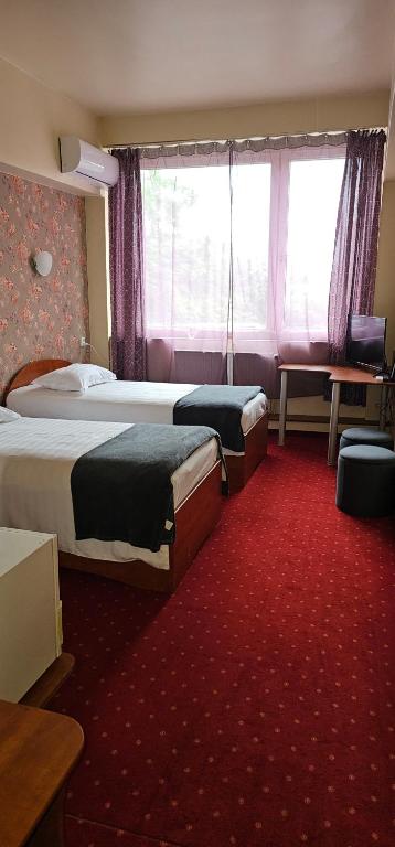 Postel nebo postele na pokoji v ubytování Hotel Olimp