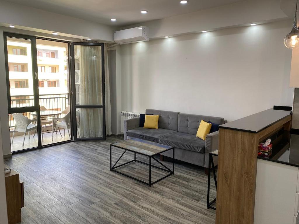 a living room with a couch and a table at Luxury - Premium Location 1 Bedroom Apartment in Yerevan