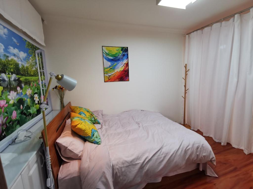 Postel nebo postele na pokoji v ubytování Yipinshiguang B&B
