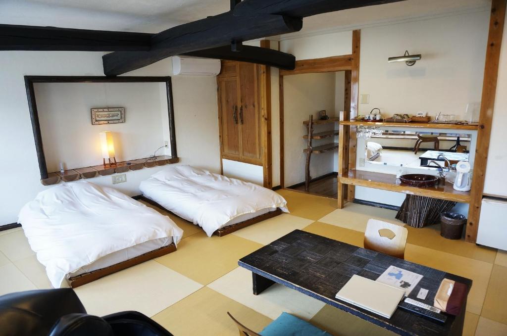 Postel nebo postele na pokoji v ubytování ワインとお宿千歳Chitose