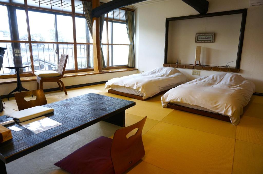 Postel nebo postele na pokoji v ubytování ワインとお宿千歳Chitose