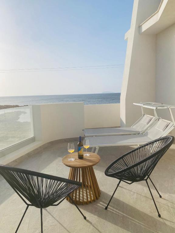 a patio with two chairs and a table and the ocean at Villa La Bella Vita in Petrosino