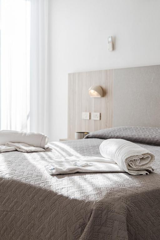 Postel nebo postele na pokoji v ubytování Hotel Astrid