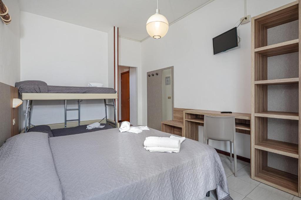 Postel nebo postele na pokoji v ubytování Hotel Astrid