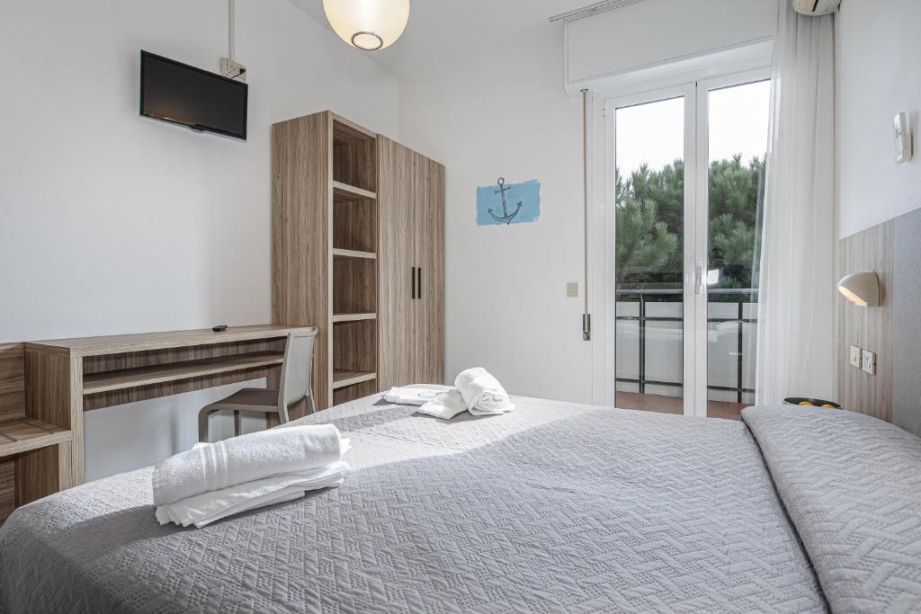 Postel nebo postele na pokoji v ubytování Hotel Astrid