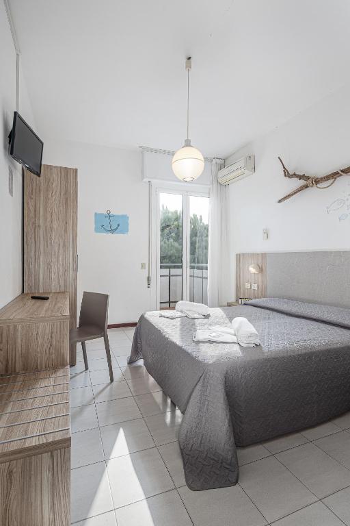Postel nebo postele na pokoji v ubytování Hotel Astrid