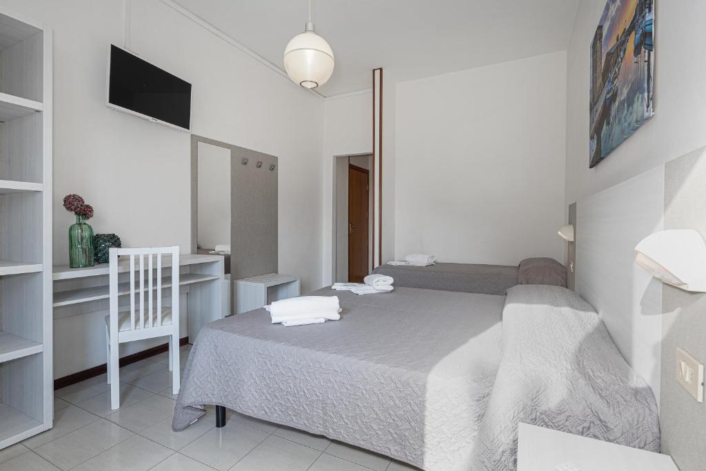 Postel nebo postele na pokoji v ubytování Hotel Astrid