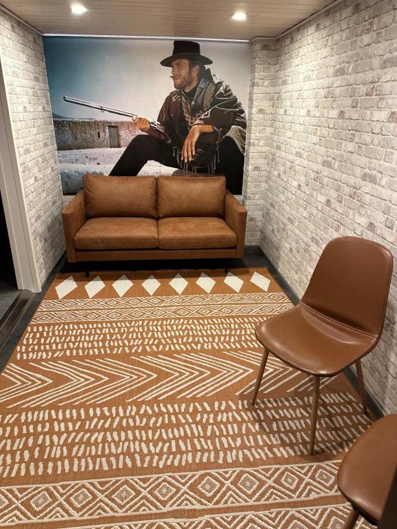 a living room with a couch and a painting of a cowboy at Luxury City Apartments, Downtown Loft House with Private Sauna in Rovaniemi