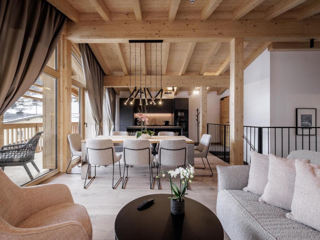 a dining room and living room with a table and chairs at Leni Mountain Lodge in Sölden