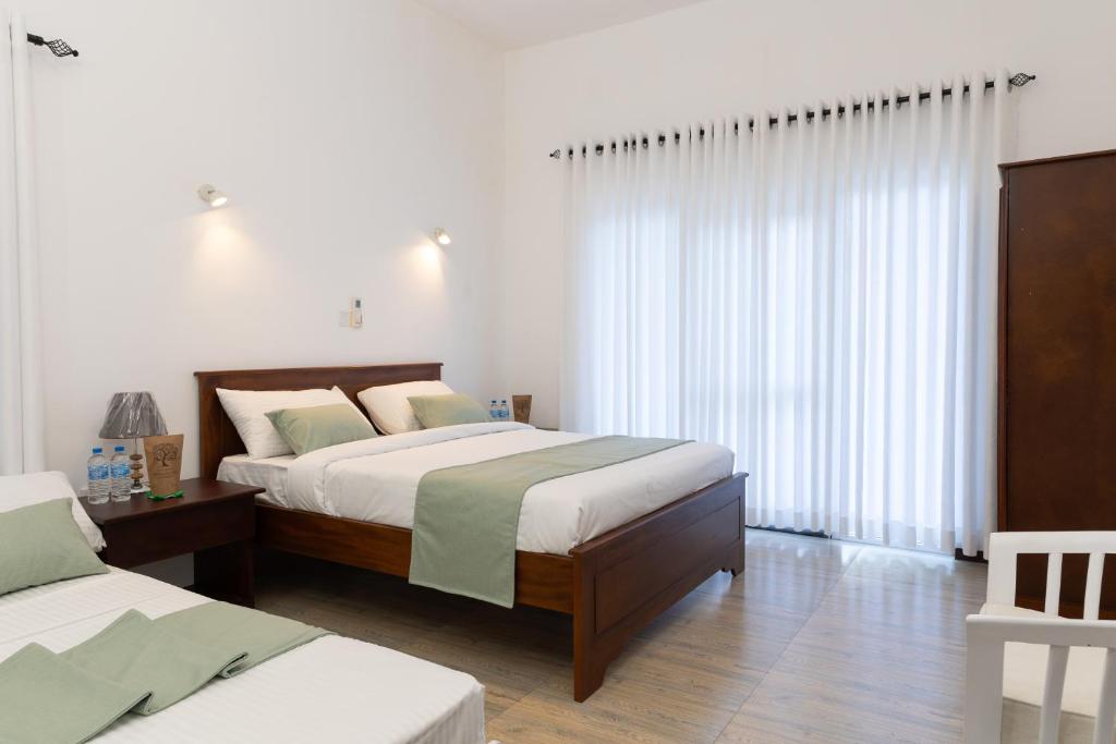 Postel nebo postele na pokoji v ubytování Greenwood Edge Kandy