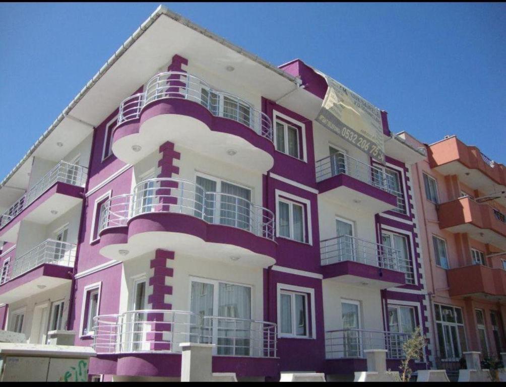 a purple and white building with balconies on it at canakkale Merkez Sefer apartmanı 15 in Canakkale