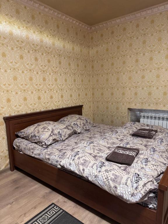 a bedroom with a bed with two pillows on it at Отель біля озера in Mukacheve