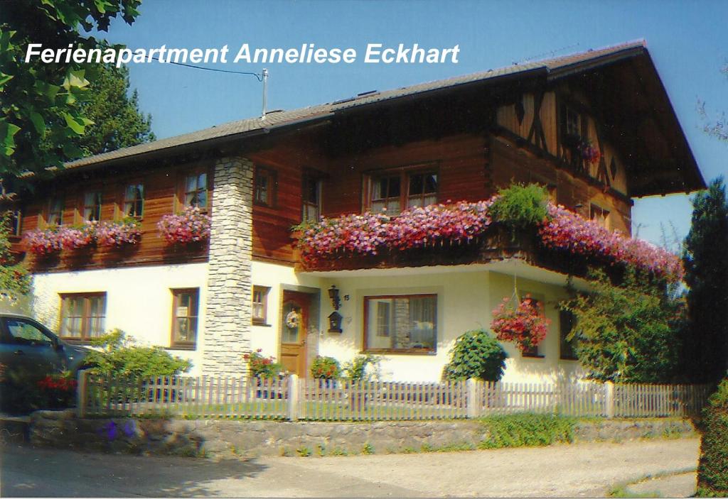 a house with flowers on the side of it at Ferienwohnung Anneliese Eckhart in Anger