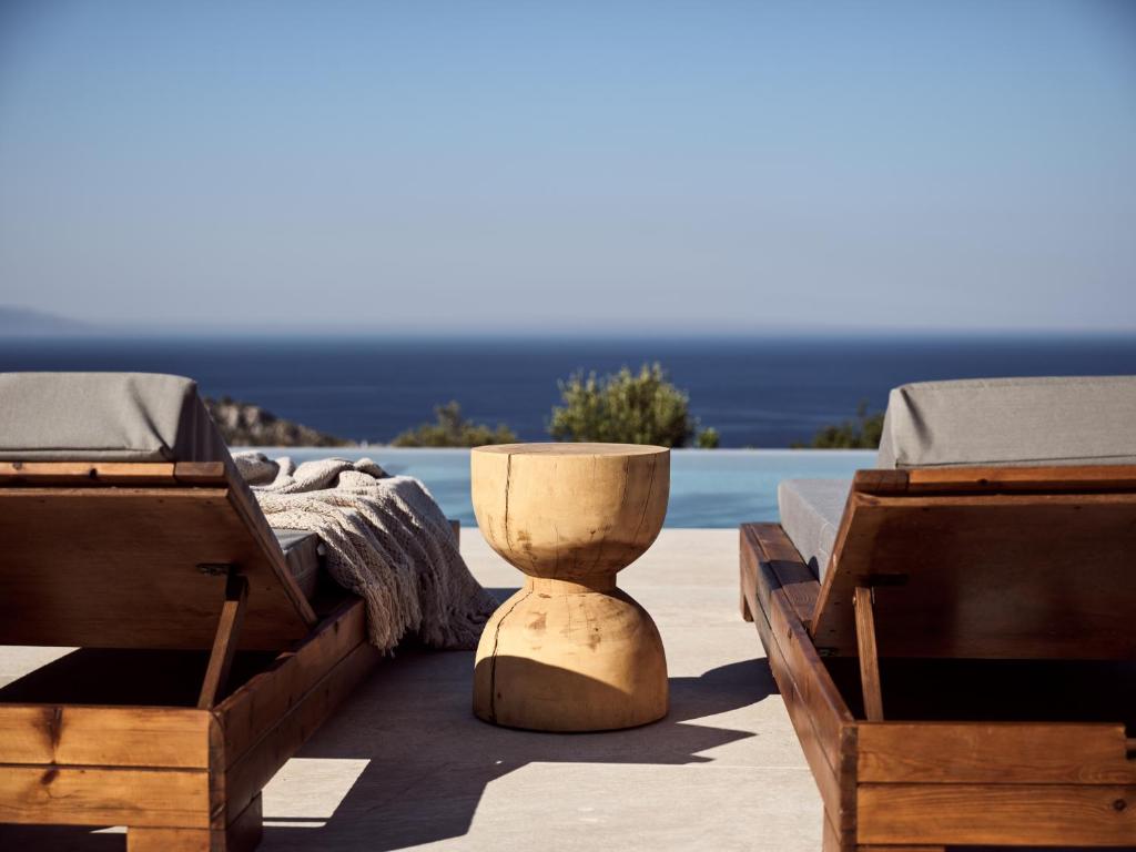 a vase sitting on a patio with two beds at Zakynthos Villa with Stunning Views in Agios Nikolaos