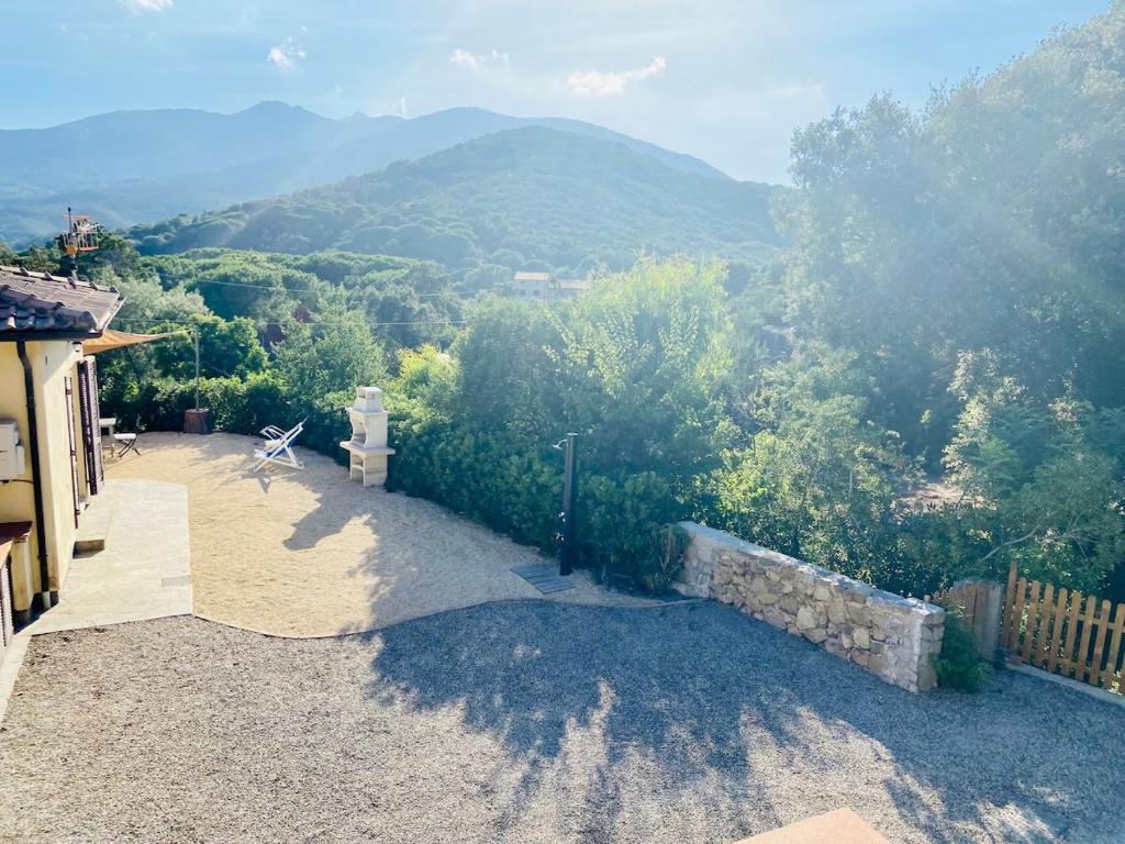 a patio with a view of a mountain at Casa del Colle, con parcheggio privato sul mare! in Procchio