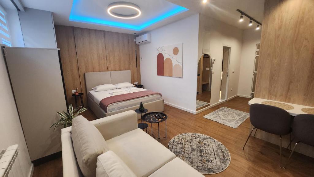 a living room with a couch and a bed at Apartmani Dobrinja - Free parking in Sarajevo